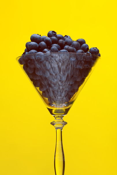 Non-alcoholic drinks concept. Fresh blueberries in shining conic glass - Fotografie, Obrázek