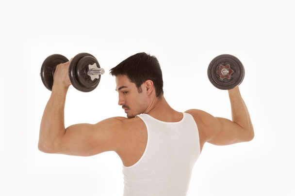 Man from back lifting weights looking shoulder - Foto, Imagen