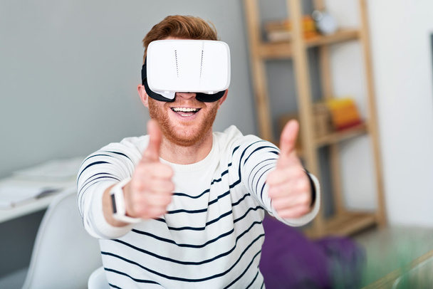 Joyful man using virtual reality device - 写真・画像