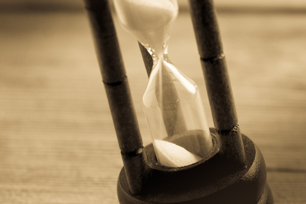 Close-up Hourglass on wood background , antique tone - Photo, Image