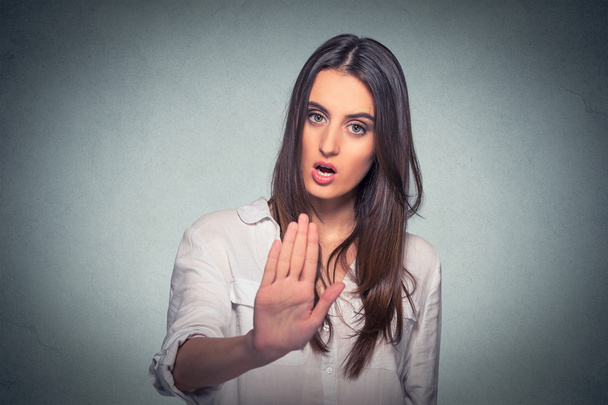 annoyed angry woman with bad attitude giving talk to hand gesture - 写真・画像