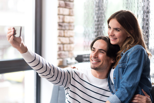 Cheerful couple making selfies - Фото, изображение
