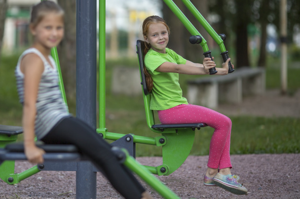  ragazze sedute su attrezzature di esercizio
 - Foto, immagini