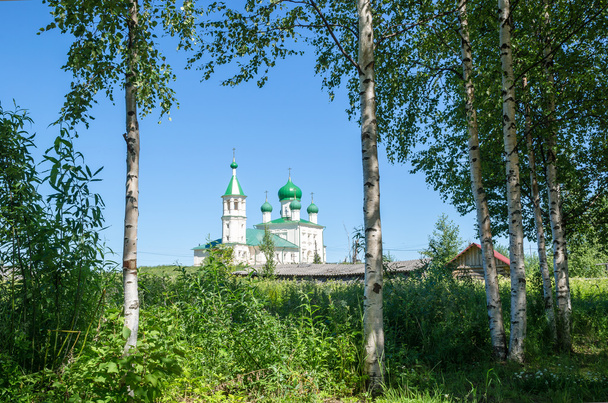 Old Russian Church on a background of birch trees - 写真・画像