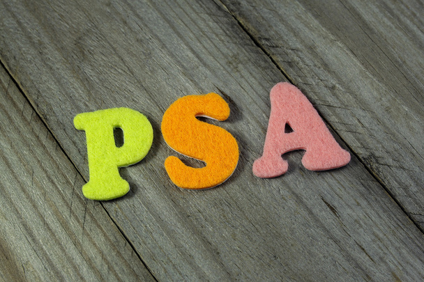 PSA (Prostate-specific antigen) acronym on wooden background - Fotoğraf, Görsel
