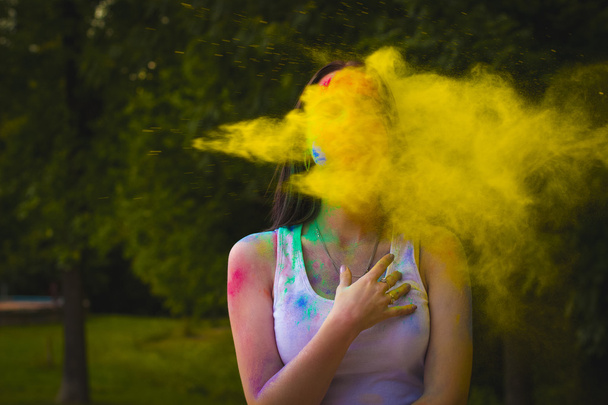 Portrait of woman with powder blowing on her face - Photo, Image