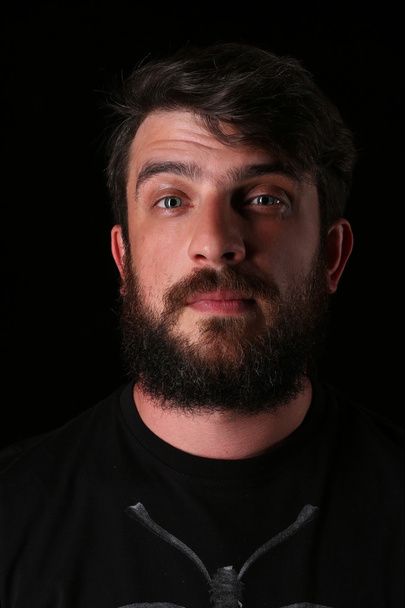 Portrait of bearded guy with interesting look. Close.up. Black - Photo, Image