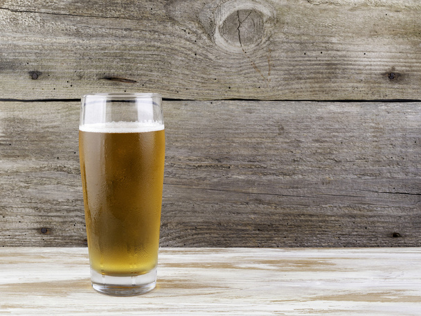 Glass of light beer on wooden background - Photo, Image