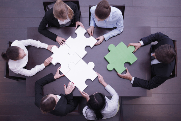 Business people assembling puzzle  - Фото, зображення