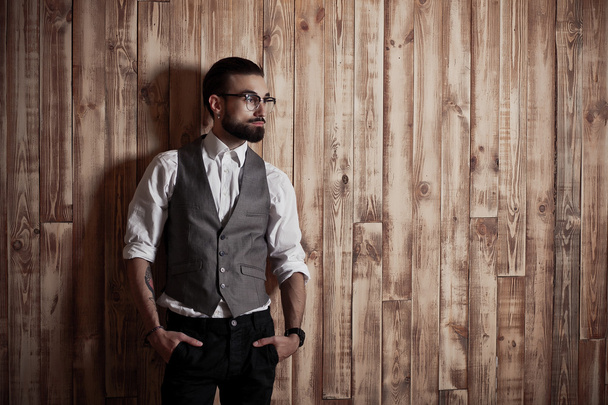 stylish man in formal clothing on a wooden background, - Foto, Imagen