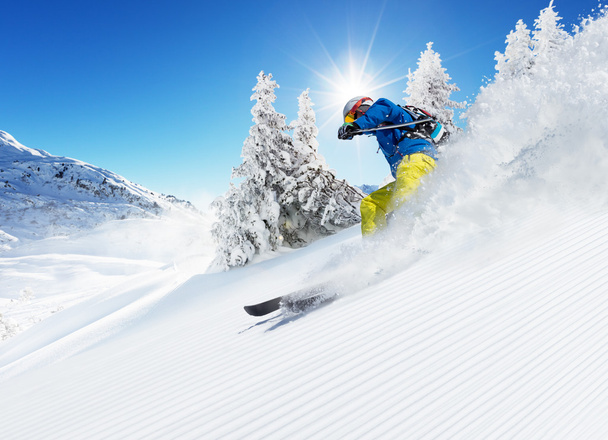 Skier on piste running downhill - Фото, изображение