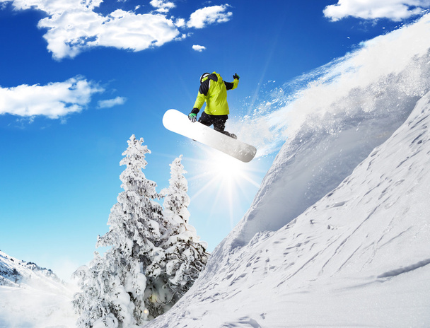 Snowboarder at jump in Alpine mountains - Photo, Image