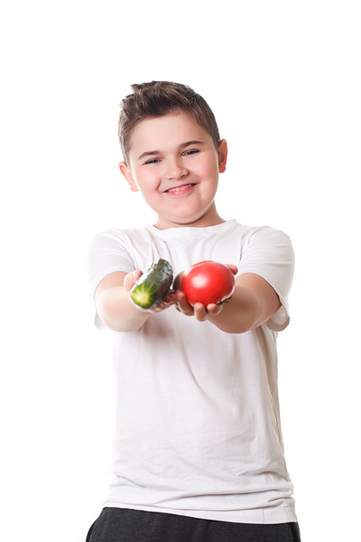 Healthy boy with food on a white background in the studio,  - Foto, Bild