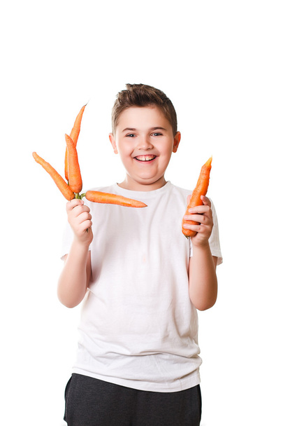 funny boy showing a carrot on a white background in the studio,  - Photo, Image