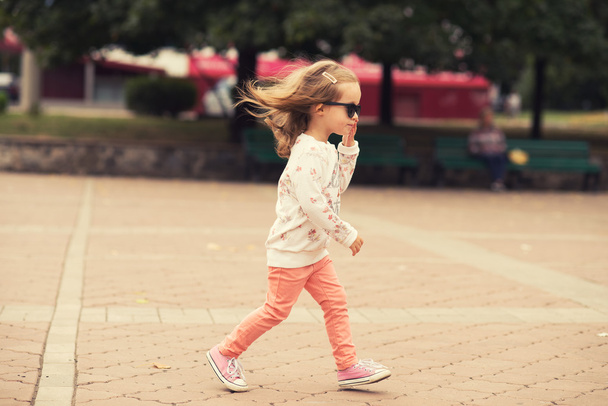 Stylish toddler girl model posing on street - Foto, Imagem