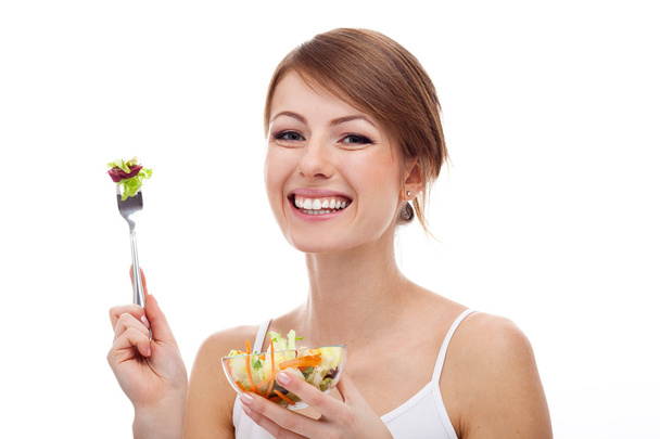 Woman with salad on fork, isolated - Photo, Image