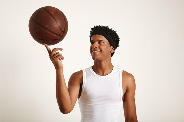 player balancing leather basketball on finger - Foto, immagini
