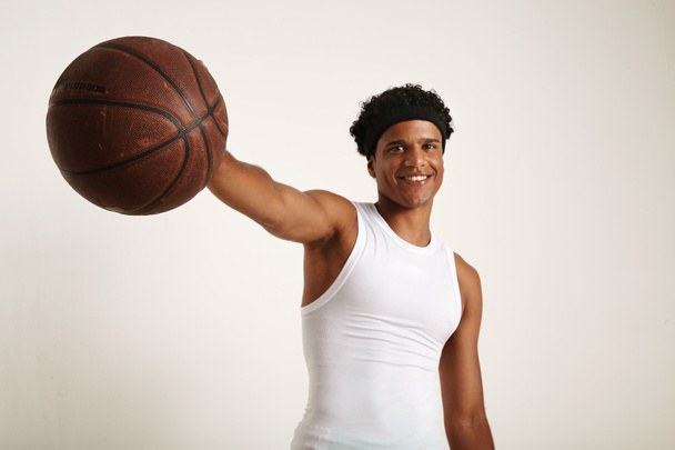 American model holding out a basketball - Fotó, kép