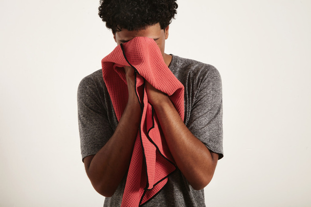black sportsman wiping his face with red towel - Фото, зображення