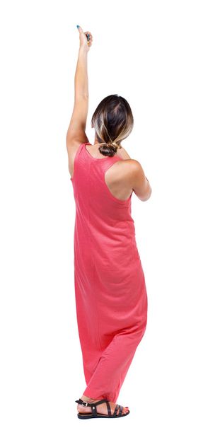 back view of standing girl pulling a rope from the top or cling - Foto, immagini