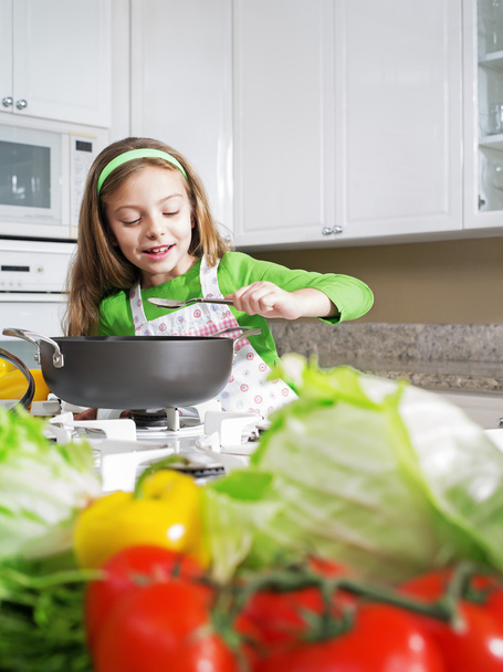 view of young beautiful girl cooking at the kitchen - Foto, imagen