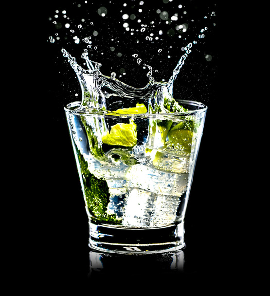 Mojito cocktail on black background with splash - Photo, Image