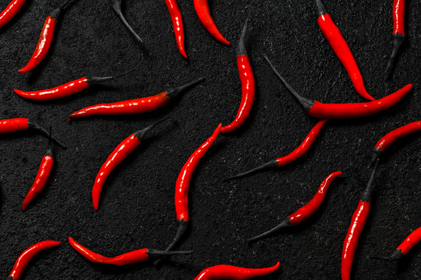 Red chilli pepper with smoke on Isolated black background, - Foto, imagen