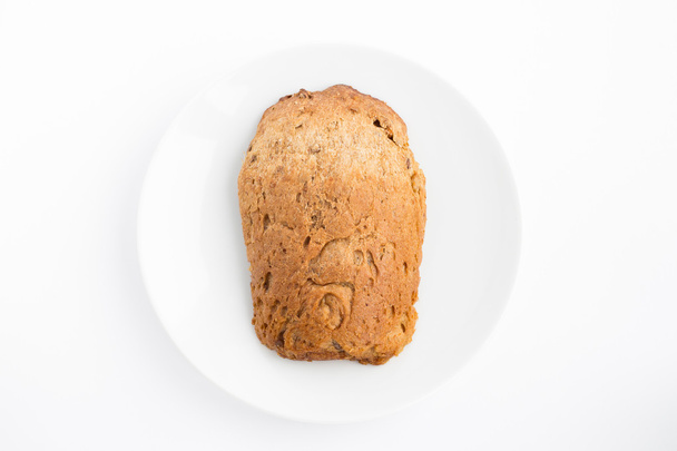 Slice of bread on a white plate - Фото, зображення