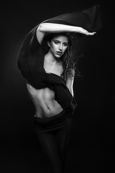 Young fashion Greek model holding a white black fabric blown by the wind isolated studio shot - Fotoğraf, Görsel
