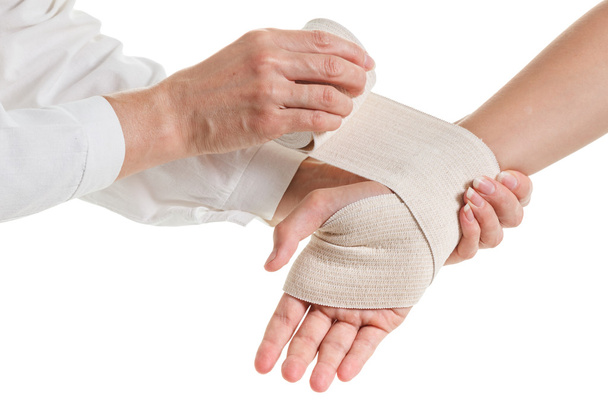 Doctor imposes an elastic bandage to the patient's hand - Foto, Imagen