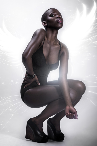 Black African American British fashion model with perfect skin lingerie studio portrait - Fotó, kép