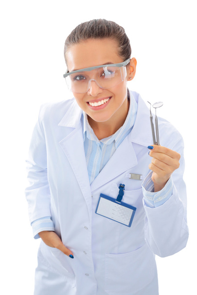 A young dentist with a tool on a white background - Photo, image