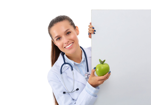 Smiling doctor with apple and blank banner - Foto, Imagen
