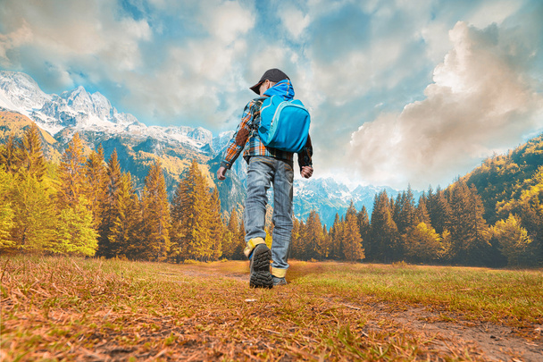 boy with backpack walking in nature - Foto, imagen