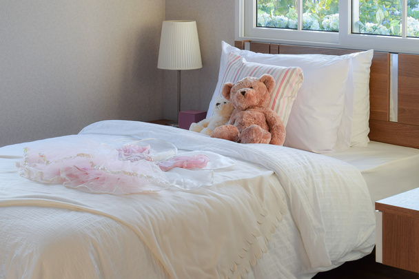 white bedroom decorative with pillows and dolls on bed - Foto, Bild