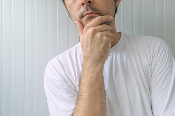 Man with hand on chin thinking deep thoughts - Photo, Image