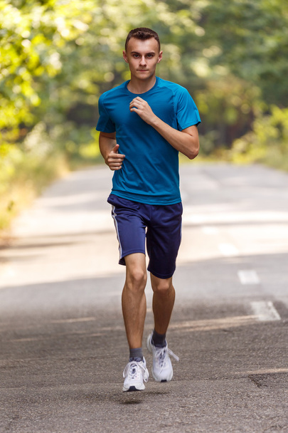 Young man running  - Фото, изображение