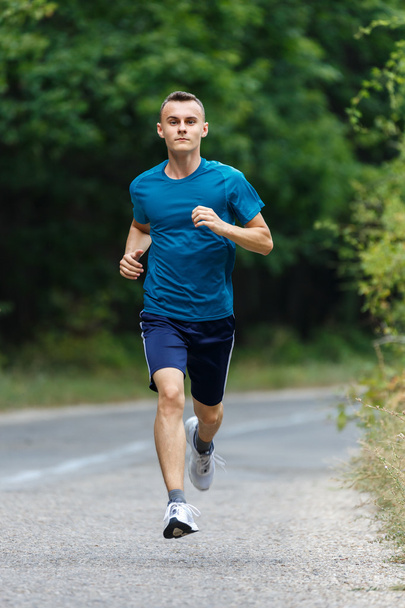 Young man running  - Valokuva, kuva