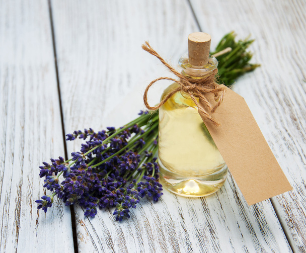 Bottle with oil, empty tag and lavender flowers - Photo, Image