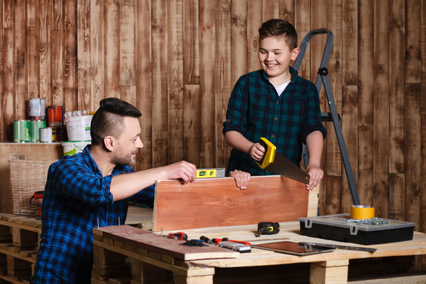 construction of father and son in the garage, family concept - Photo, Image