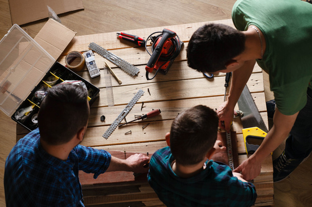 construction of father and son in the garage, family concept  - 写真・画像