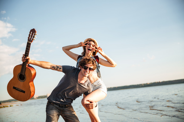 Portrait of a young couple having fun on the beach - Foto, Imagen
