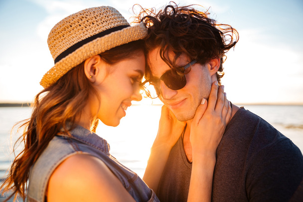Closeup of happy young couple on the beach - 写真・画像