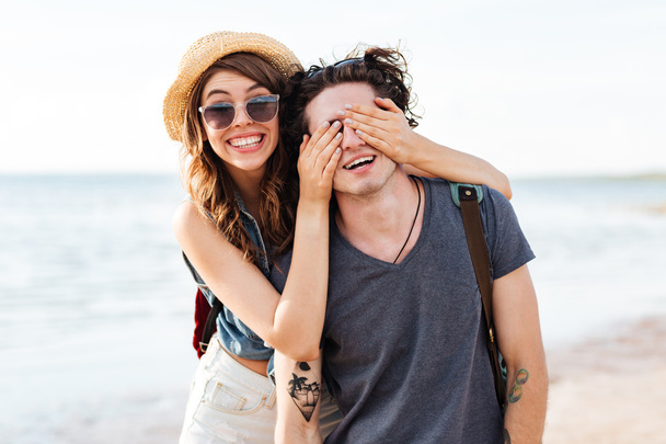 Cheerful young couple having fun on the beach - Photo, image