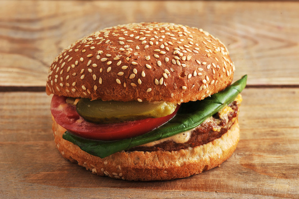 fast food hamburger  on a wooden background  - Photo, Image