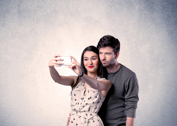 Happy couple taking selfie with clear wall - Фото, изображение