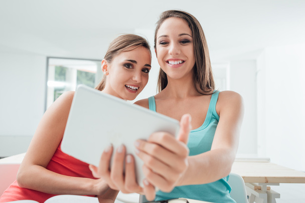 Girls social networking with a tablet - Фото, зображення
