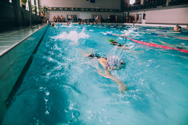 Mensen zwemmen in overdekt zwembad - Foto, afbeelding