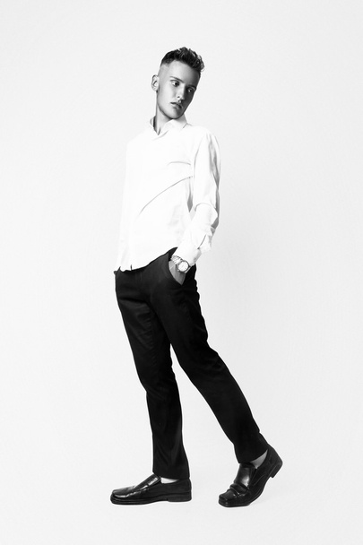 Fashion young businessman black suit casual poses at studio. Black and white - Φωτογραφία, εικόνα