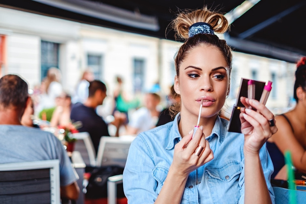 Девушка чинит макияж в кафе
 - Фото, изображение